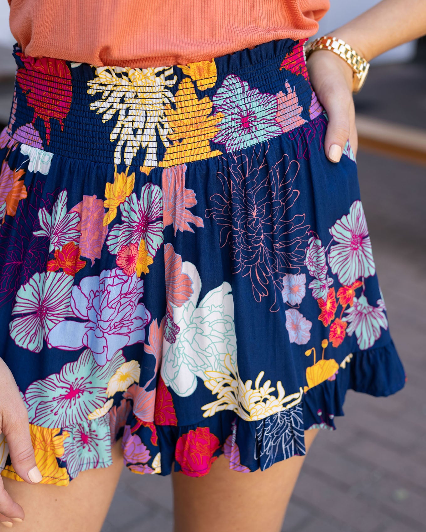Close up view of sketched floral smocked shorts