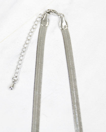 close up stock shot of silver snake chain necklace clasp