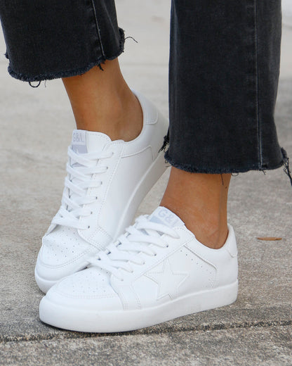 side view of white star sneakers