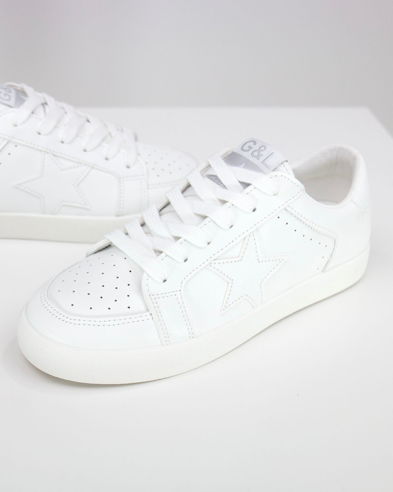 side view stock shot of white star sneakers