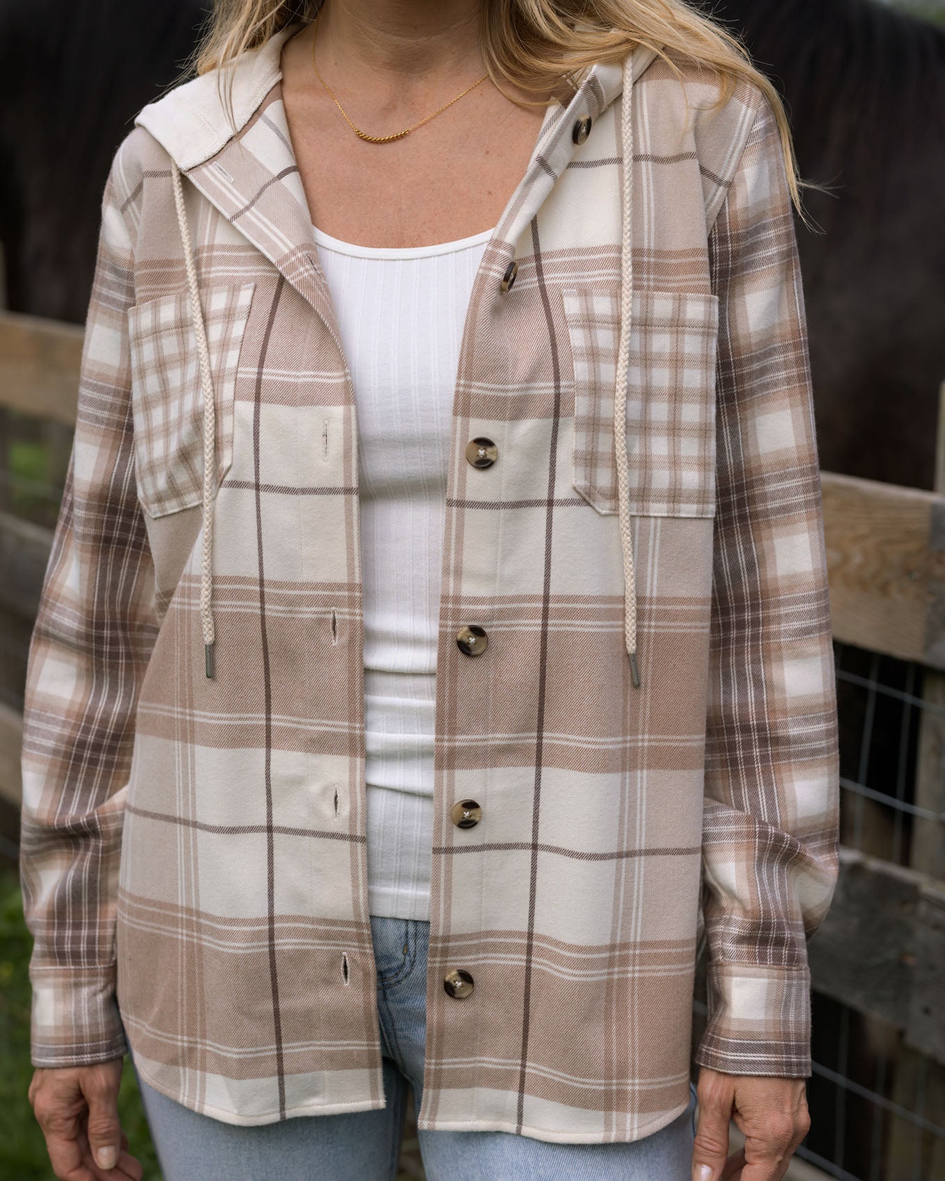 close up view of mixed neutral plaid hooded shacket