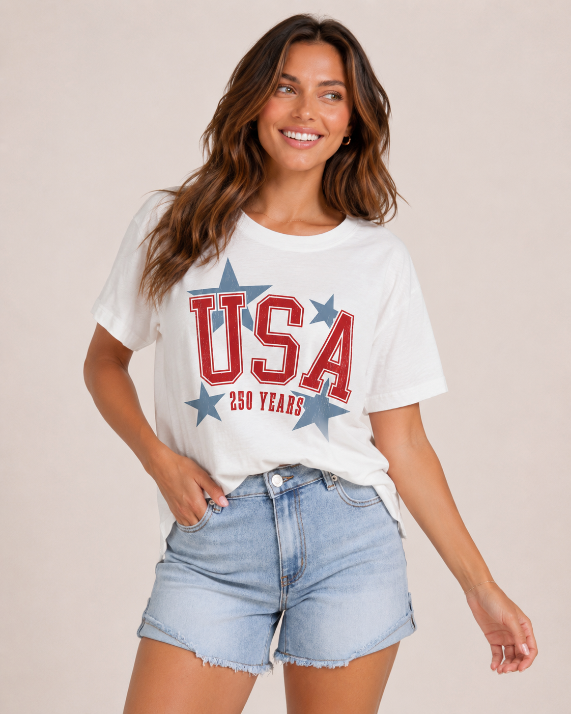Woman wearing a white t-shirt with 'USA 250 Years' text and blue shorts on a beige background