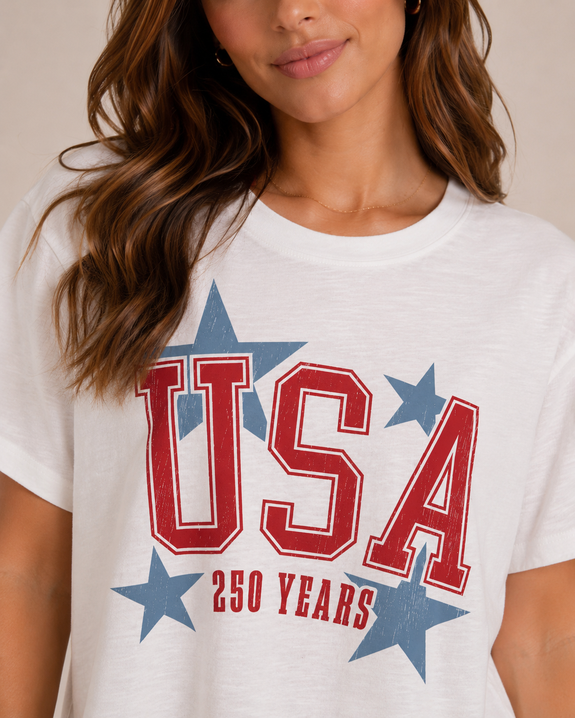Woman wearing a white t-shirt with 'USA 250 Years' design
