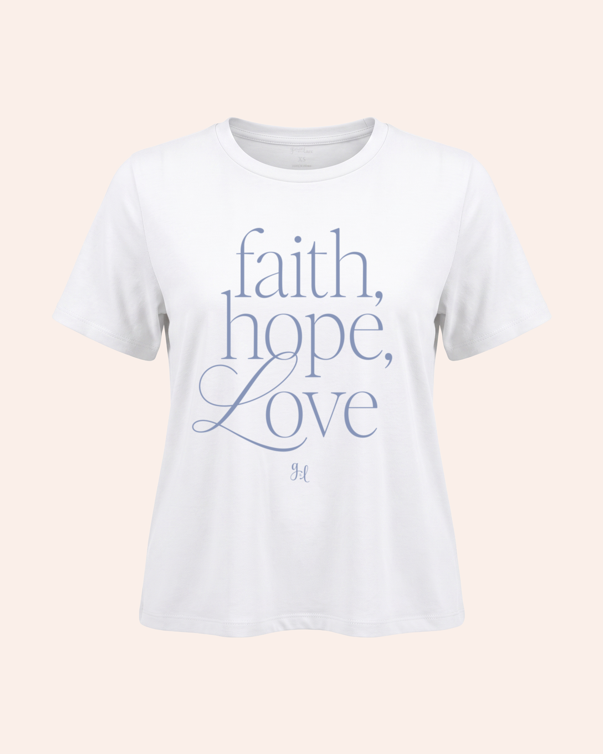 White t-shirt with 'faith, hope, love' text on a light pink background