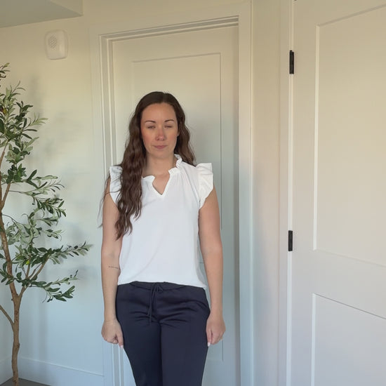 Kaitlyn Wearing Ruffle Collar Top in Off White and Navy Scuba Pants
