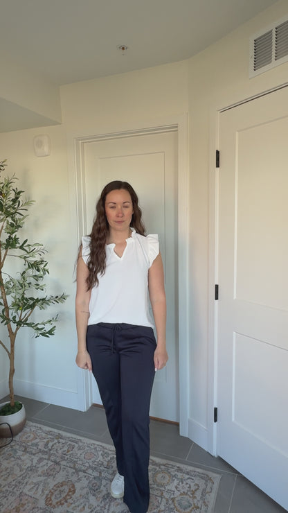 Kaitlyn Wearing Ruffle Collar Top in Off White and Navy Scuba Pants
