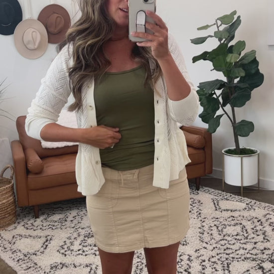 Try-on video of a model wearing the Flawless Fit Spaghetti Strap Tank in Olive.