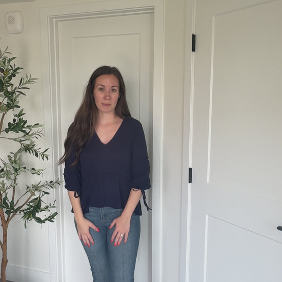 Try-on video of a model wearing the Soft Romance Peplum Blouse.