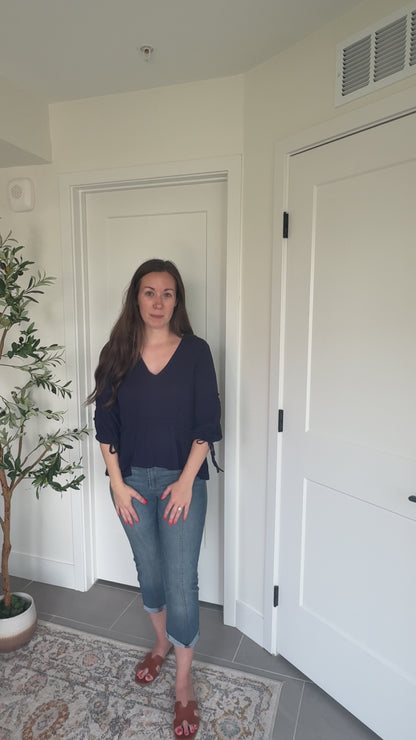 Try-on video of a model wearing the Soft Romance Peplum Blouse.