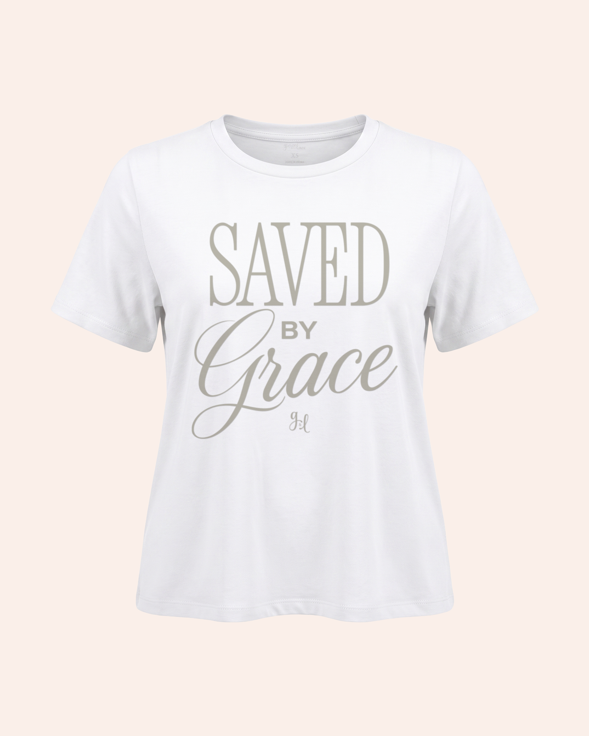 White t-shirt with 'Saved by Grace' text on a light pink background
