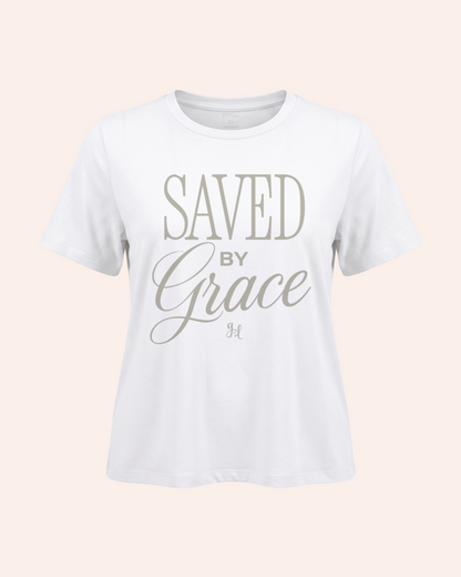 White t-shirt with 'Saved by Grace' text on a light pink background