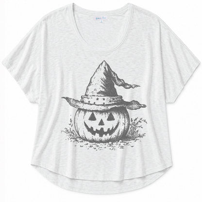 White graphic tee with a vintage-inspired pumpkin and witch hat design on a beige background