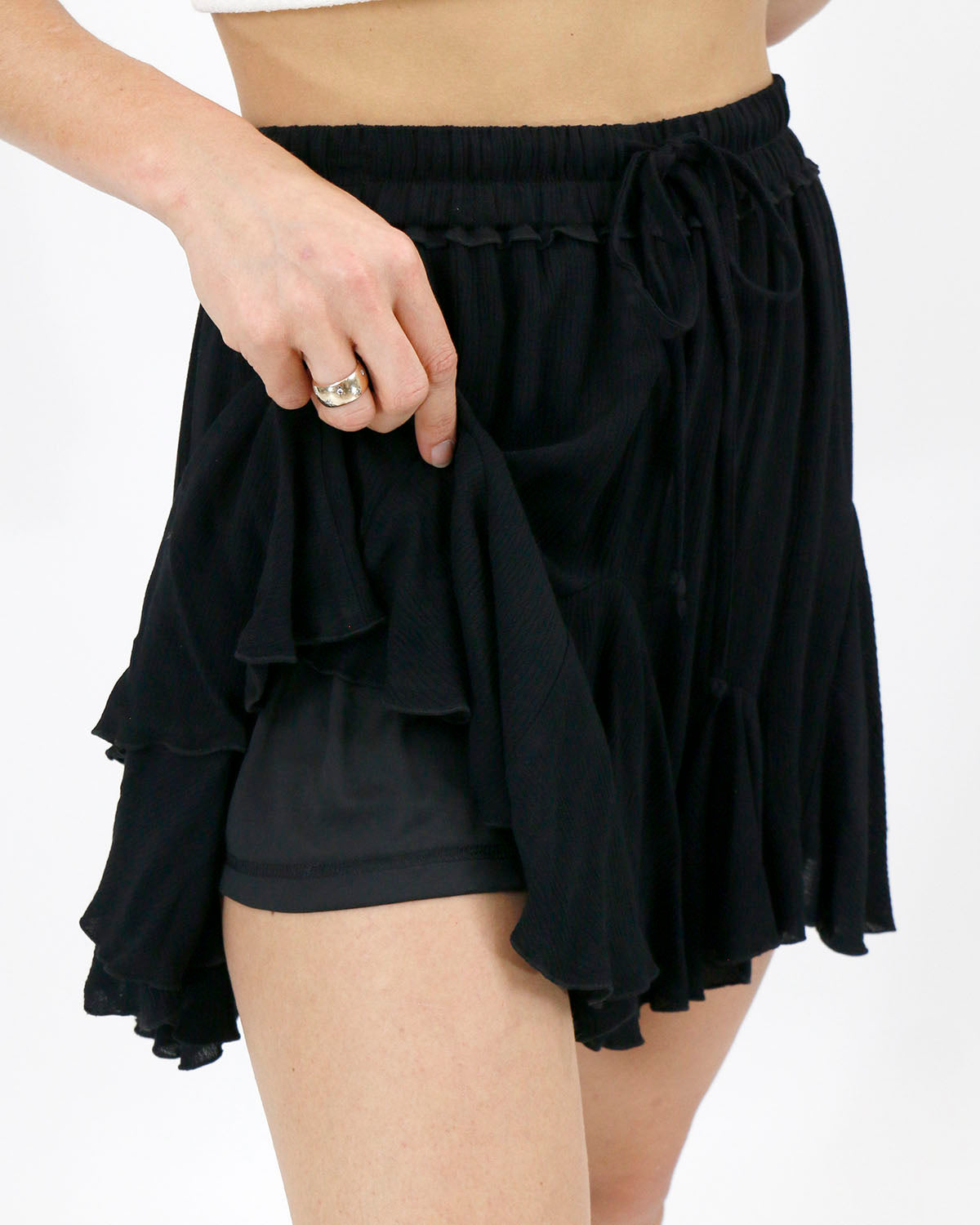 view of attached shorts underneath black flutter skirt 