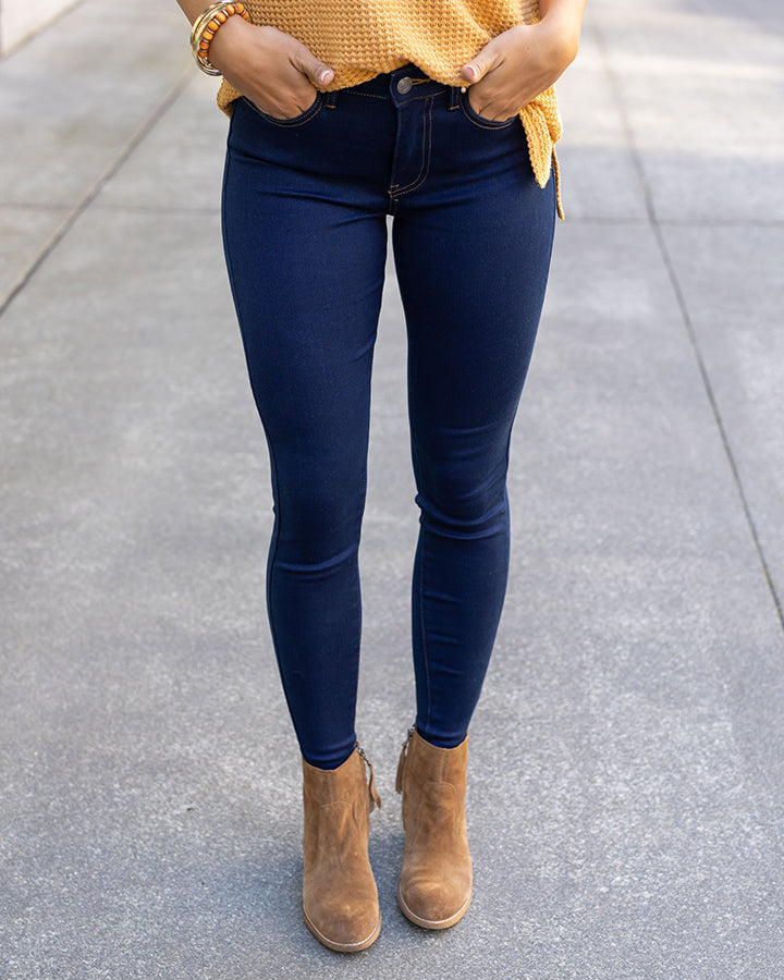 All day denim worn by woman with gold top